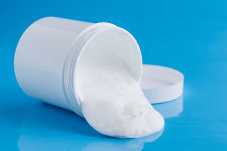 Protective sunscreen or sunblock cream and sunbath sun care lotion in white plastic bottlesの写真素材