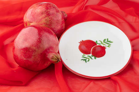 pomegranate fruit on table with pictureの写真素材