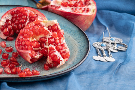 ripe pomegranate on a table on a blue backgroundの写真素材