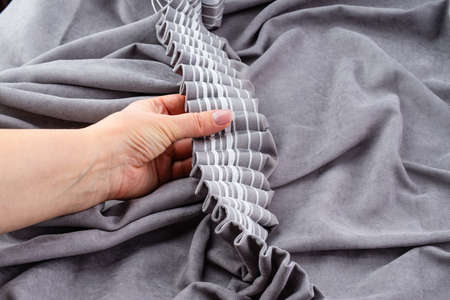 Close up of woman hands hanging curtainの写真素材