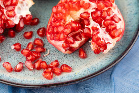 Composition with ripe pomegranates on blue tableの写真素材