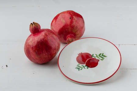 pomegranate fruit on table with pictureの写真素材