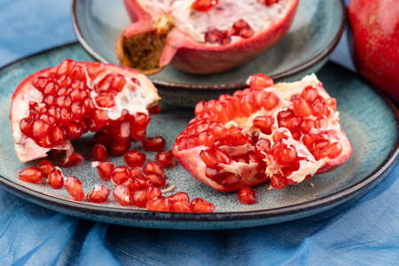 Composition with ripe pomegranates on blue tableの写真素材