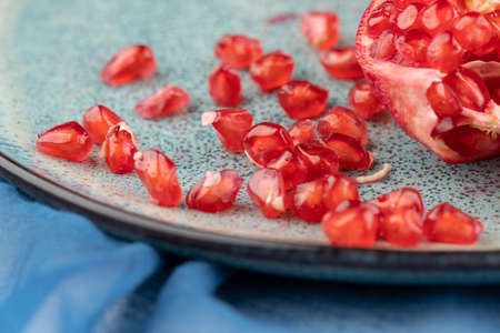 Composition with ripe pomegranates on blue tableの写真素材