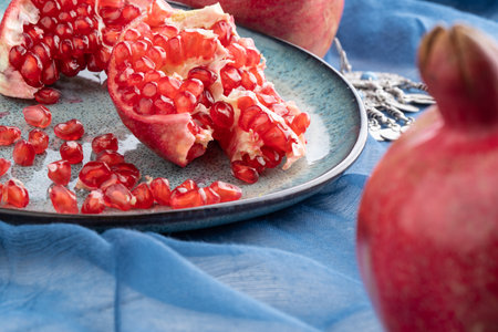 Composition with ripe pomegranates on blue tableの写真素材