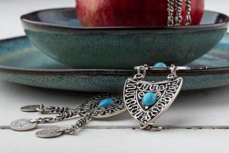 Turkish pomegranate fruit with turkish jewelery and open pomegranate, side viewの写真素材