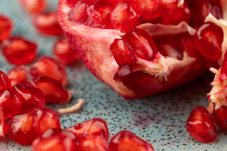Composition with ripe pomegranates on blue tableの写真素材