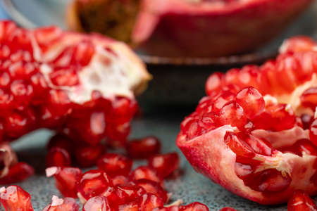 Composition with ripe pomegranates on blue tableの写真素材