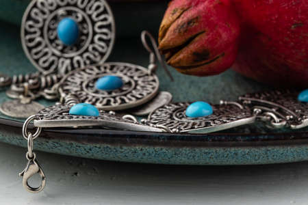 Turkish pomegranate fruit with turkish jewelery and open pomegranate, side viewの写真素材