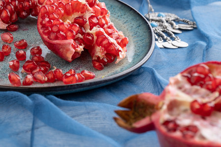 Composition with ripe pomegranates on blue tableの写真素材