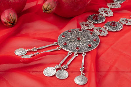 Turkish pomegranate fruit with turkish jewelery and open pomegranate, side viewの写真素材