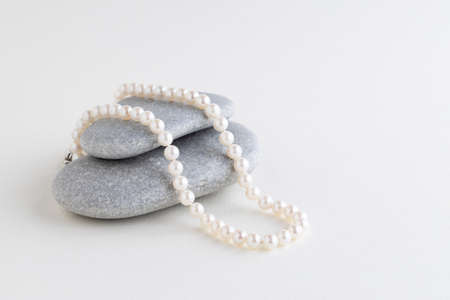box is tied with a necklace of pearls. Copy space.Holiday conceptの写真素材