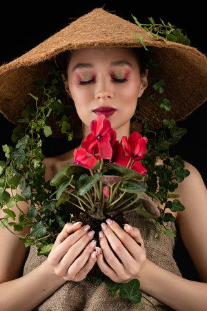 woman transplanted flower in a ceramic pot. houseplant transplant concept.の写真素材