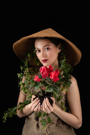 woman transplanted flower in a ceramic pot. houseplant transplant concept.の写真素材