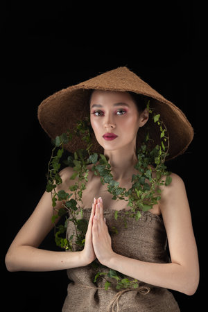 Beauty Spring or Woman with Fresh green leaves hat. nature girl portraitの写真素材