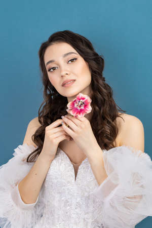 Attractive young woman with fresh skin. Face care, facial treatment, woman beauty skin on blue background. cosmetology, beauty skin and cosmetic conceptの写真素材