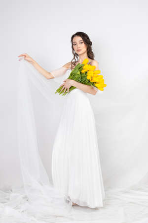 Tulips, woman with flower yellow tuli, female portraitの写真素材