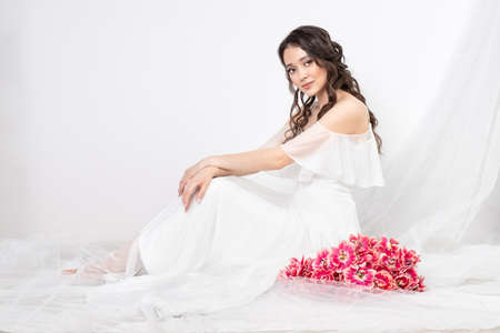Girl with a bouquet of pink tulips. Girl with a gift of flowersの写真素材