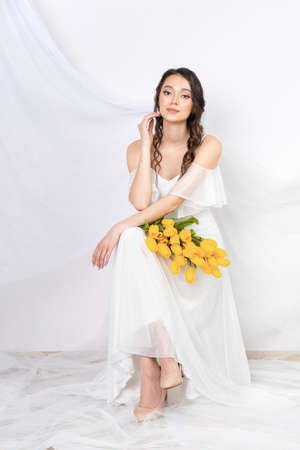 Tulips, woman with flower yellow tuli, female portraitの写真素材