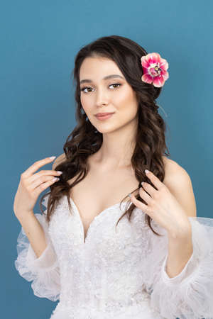 Attractive young woman with fresh skin. Face care, facial treatment, woman beauty skin on blue background. cosmetology, beauty skin and cosmetic conceptの写真素材
