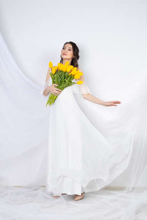 Tulips, woman with flower yellow tuli, female portraitの写真素材