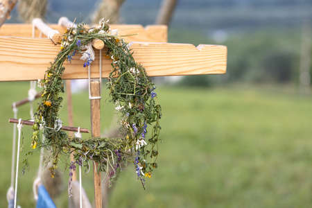 a wreath of meadow grass on a wooden platformの写真素材