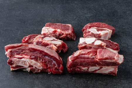 Raw beef meat osso buco shank steak, italian ossobuco. black backgroundの写真素材