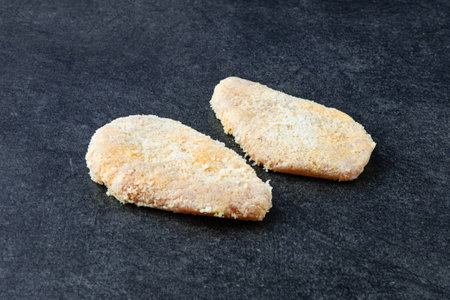 Frozen Chicken Cutlet on Stone Background. Frozen Semi-finished Productsの写真素材