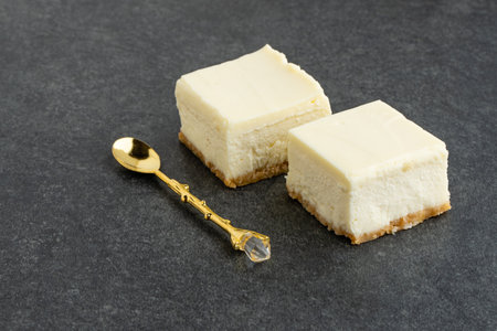 Slice of plain New York Cheesecake on stone tableの写真素材
