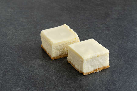Slice of plain New York Cheesecake on stone tableの写真素材