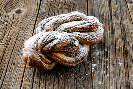 Freshly baked sweet buns on wood tableの写真素材