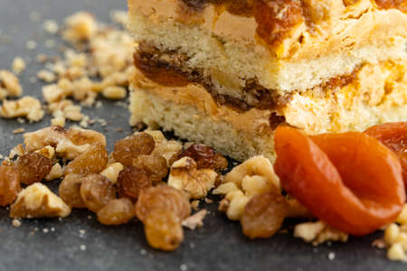 tartlet with nuts and fruits poured with caramel, the ingredients used in the tartlet are hazelnuts, peanuts, dried apricots, dried plums, dried walnutsの写真素材