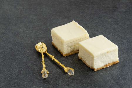 Slice of plain New York Cheesecake on stone tableの写真素材