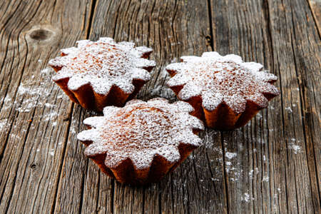 Freshly baked sweet buns on wood tableの写真素材