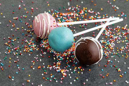 various homemade cake pops on dark stoneの写真素材