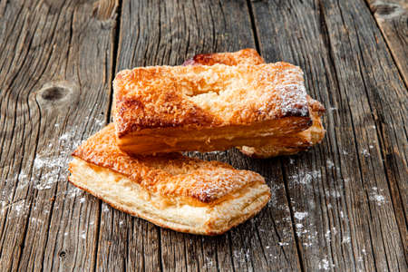 Freshly baked sweet buns on wood tableの写真素材