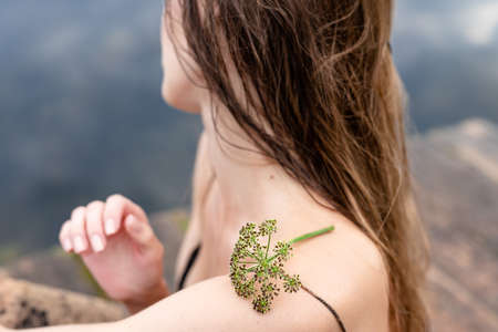 Hand of woman touching blossoming flowers