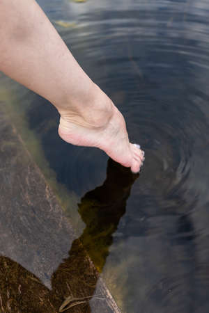 Feet immersed in the clear water, Feet in water. Selfie of legs and barefoot. vacation at summer holidayの写真素材
