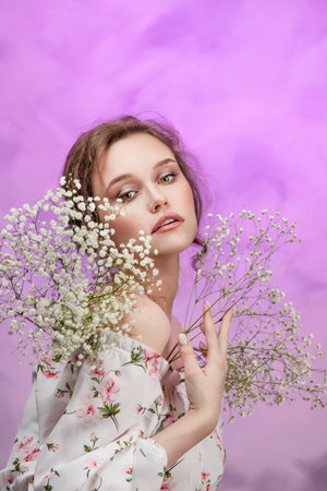 Close up of happy woman smelling wild flowers. female being with natureの写真素材
