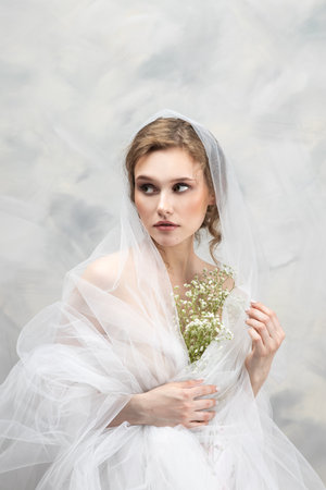 pregnancy, holidays and people concept - happy pregnant woman with flowersの写真素材