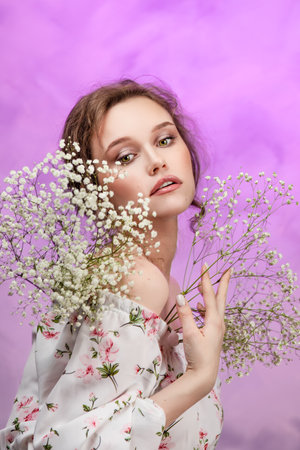 Close up of happy woman smelling wild flowers. female being with natureの写真素材