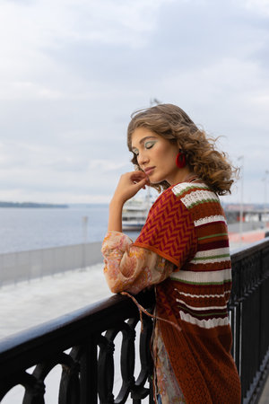 Portrait of a beautiful girl on the background of the embankment of a large riverの写真素材