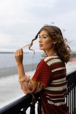 lifestyle of an elegant young woman on the embankment of a large riverの写真素材