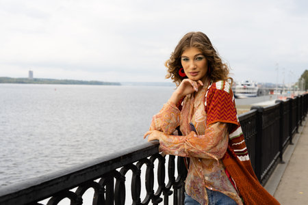 lifestyle of an elegant young woman on the embankment of a large riverの写真素材