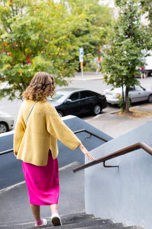 Beautiful woman walking down the streetの写真素材