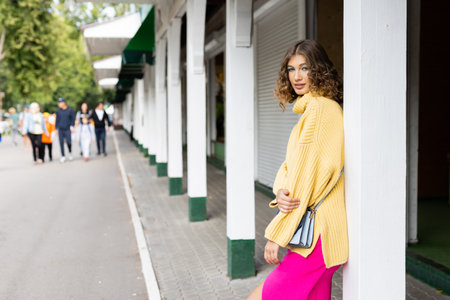 Beautiful woman walking down the streetの写真素材