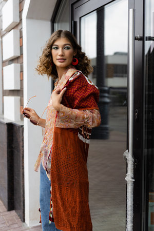 lifestyle elegant young woman standing down the street in a trendy outfitの写真素材