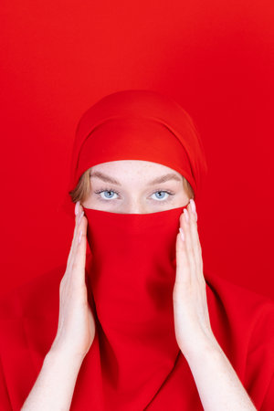 religious woman in red hijab, concept of shows protestの写真素材