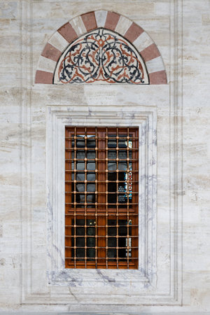 beautiful window on a historic building with metal barsの写真素材