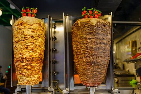 Grilled chicken meat on a vertical rotisserie used in traditional turkish street food Doner Kebab (Shawarma or Gyros in other cultures) in Istanbul, Turkeyの写真素材